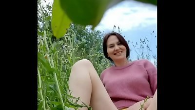 bare mischievous milf in a chamomile field masturbates, pisses and wards off a wasp / Angela-MILF